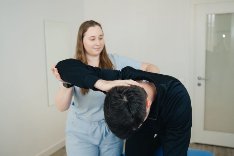 Person using a warm compress on the lower back while seated comfortably at home.